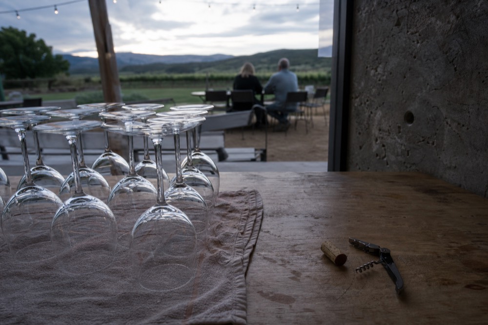 A winery bar top with empty stemmed glasses waiting for a tasting pour, no text, no logos, no people