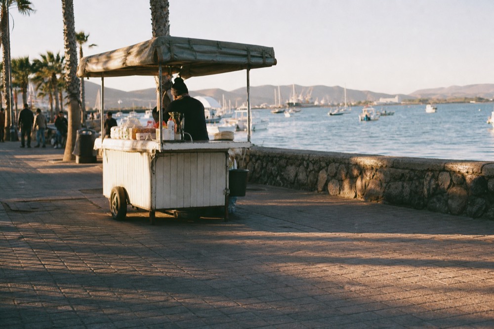 Ensenada malecon waterfront with boats in the harbor, no text, no logos, no people